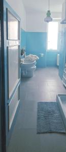 a blue bathroom with two toilets and a sink at La Casetta Sul Corso in Ischia Town +10 photos
