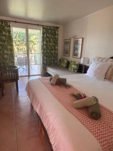 a hotel room with two beds with towels on them at Karibbean Resort in Sainte-Luce +37 photos