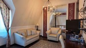 a living room with two chairs and a television at Villa Jurmala in Jūrmala