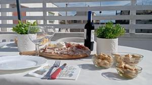 a table with a plate of food and a bottle of wine at La Chiocciola in Trani