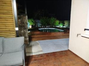 a view of a pool from a patio at night at Location Saisonnière Les Caféiers in Le Tampon