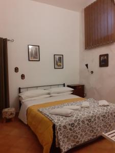 a bedroom with a bed with a blanket on it at Casa Normanna in Salerno