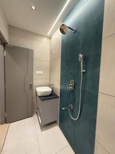 a bathroom with a shower and a sink at The Grand Sarayu in Mysore