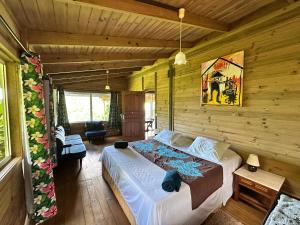 a bedroom with a bed in a log cabin at Vaka House in HUH