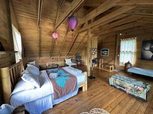 a bedroom with two beds in a log cabin at Vaka House in HUH