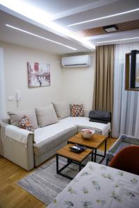 a living room with a couch and a table at Apartman North resort in Vrnjačka Banja +31 photos