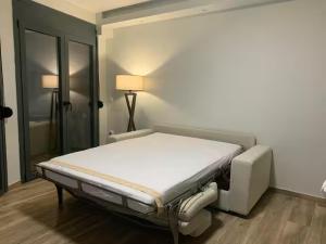 a white bed in a room with a lamp at Central & Beautiful in Sitia
