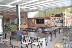 a dining room with tables and chairs and a tv at Amanecer en Cuyo in San Rafael