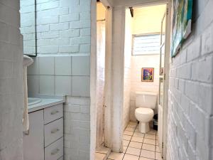 a bathroom with a toilet and a sink at DL-Cozy Chalet in Lívingston