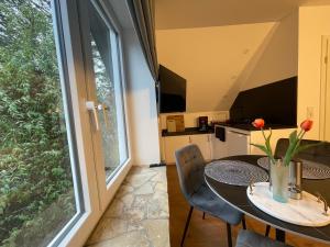 a dining room with a table and a large window at Ferienpark Worpswede in Worpswede