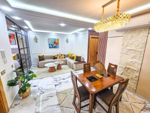 a living room with a table and a couch at Sky View by Luxurious Holidays in Rabat