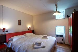 a bedroom with a large bed with towels on it at Modernist Chalet in Borca di Cadore +9 photos