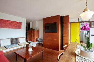 a living room with a table and a couch at Modernist Chalet in Borca di Cadore