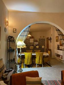 a living room with a table and yellow chairs at Maison Bohème Suite Noura in Midoun