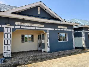 a house with a blue and white exterior at Deripacs Homes in Lodwar