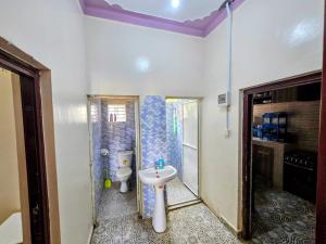 a bathroom with a sink and a toilet at Deripacs Homes in Lodwar +28 photos