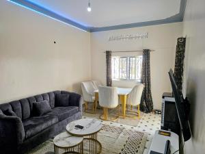 a living room with a couch and a table at Deripacs Homes in Lodwar