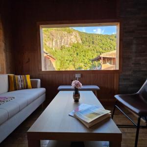 a living room with a couch and a table and a window at Cabaña 2 - Rancho Doble AA in La Junta +7 photos