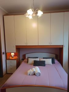 a bedroom with a large bed with white cabinets at B&b Villa Sofia in Fara Novarese
