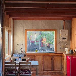 a kitchen with a table and a window at Cabaña 2 - Rancho Doble AA in La Junta