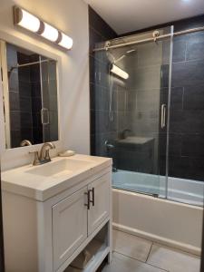 a bathroom with a sink and a glass shower at Villa Nemesio & Linsday 1 in Atlanta +31 photos