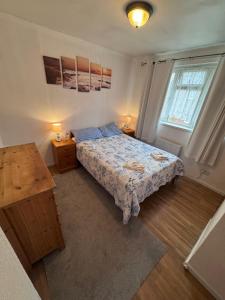 a bedroom with a bed and two tables and a window at Bula Bista 3 double rooms in Southampton
