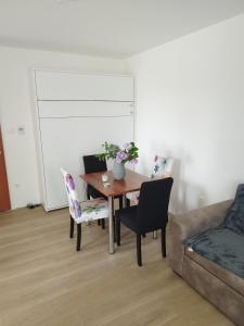 a living room with a table and chairs and a couch at Apartmán Adam in Dolní Moravice +3 photos