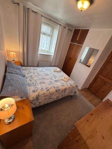 a small bedroom with a bed and a table at Bula Bista 3 double rooms in Southampton
