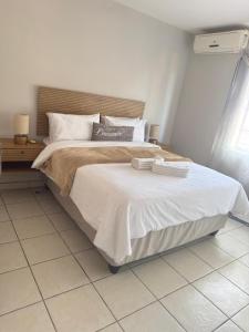 a bedroom with a large bed in a room at Kloppenheim Sectional Lifestyle Complex in Ellisras +4 photos