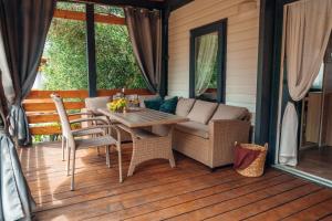 a porch with a couch and a table and chairs at House no 4 in Pakoštane