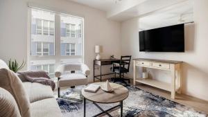 a living room with a couch and a tv at Landing Chic 2BD Gym Clubhouse in Tempe