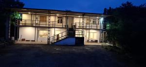 a large house with a lit up facade at night at Bhagya Resort Limited in Nikawatawana
