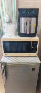 a microwave oven sitting on top of a counter at bel studio de luxe a thies Sénégal in Thiès +16 photos