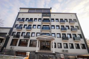 a white building with a sign on it at Hotel Global Palace in Haskovo