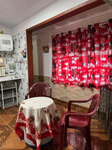 a room with a table and two chairs and a wall at La Dorada in Barra del Chuy
