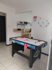 a ping pong table in the middle of a room at Sunset House Herradura in Herradura