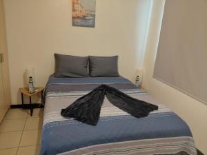 a bed with a jacket on top of it at Sunset House Herradura in Herradura +8 photos