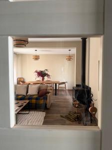 a living room with a couch and a table with a fireplace at El Corral de Tía Gloria in Pepino