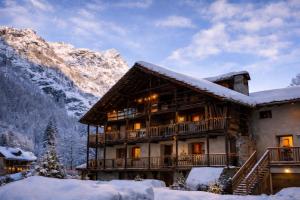 a log cabin in the mountains in the snow at Casalpina Cozy chalet in Gressoney-la-Trinité