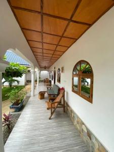 a porch with awning and a table and chairs at Hotel Eyram Kpalime in Palimé