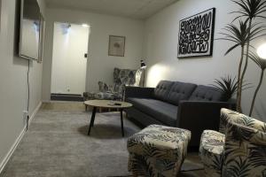 a living room with a couch and a table at Vandrarhemmet Eken in Eksjö