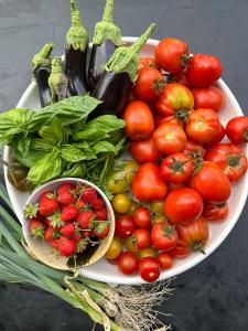 a plate of strawberries and vegetables on a table at VILLA ALBA ROSULA in Ajaccio