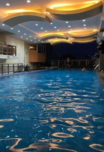 a pool of water in a building with a ceiling at Birch Tower Condominium Malate in Sampong