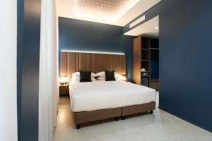 a bedroom with a large bed and a blue wall at The FLOOR in Milan