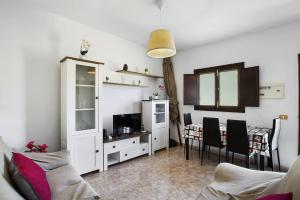 a living room with a couch and a dining room at casa La cabaña Villa Palomino in Gáldar