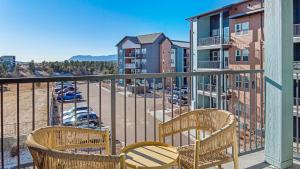 a balcony with two chairs and a view of a parking lot at Landing Stylish 2BD Gym Pool in Colorado Springs