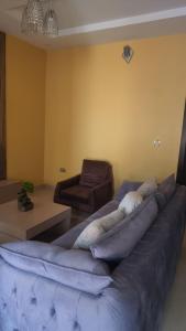 a living room with a couch with pillows on it at The Oasis in Ilorin