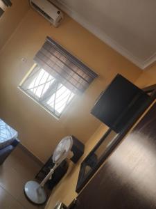 a view of a room with a toilet and a window at The Oasis in Ilorin