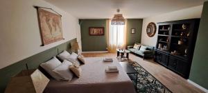 a living room with a couch and a living room with at Le MAS CLEMENTINE in Puisserguier