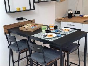a table with two plates of food on it in a kitchen at Palma's house in Cambiago